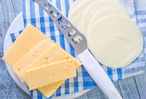 Cheese slices with a knife