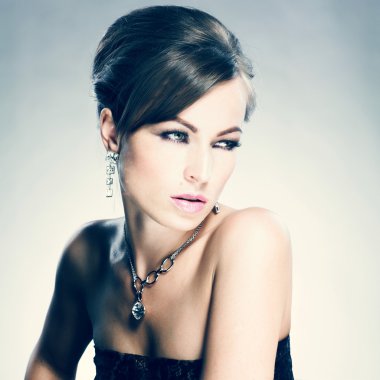 Beautiful woman with evening make-up. Jewelry and Beauty