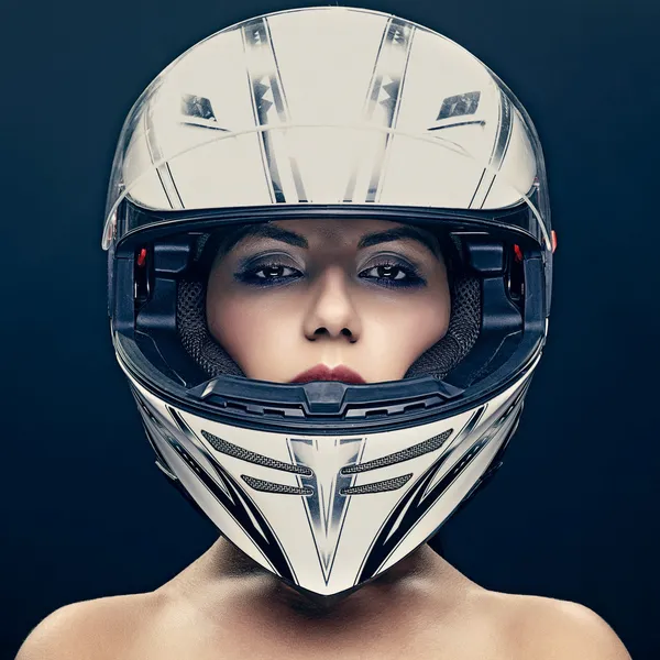 Sexy woman in helmet on dark background — Stock Photo, Image