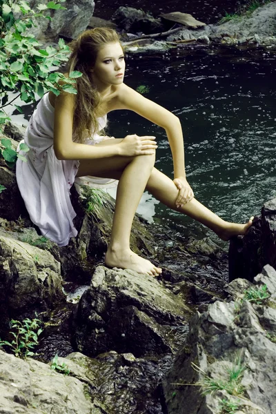 Beautiful girl on stones — Stock Photo, Image