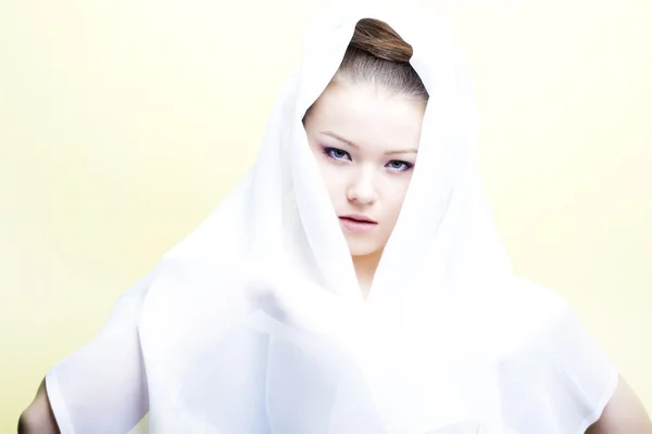 Beautiful girl enveloped in white headscarf — Stock Photo, Image