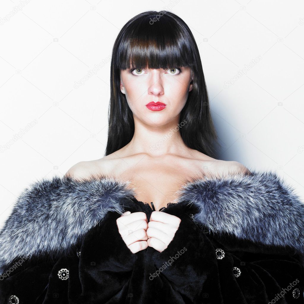 Attractive woman in blue fox fur coat