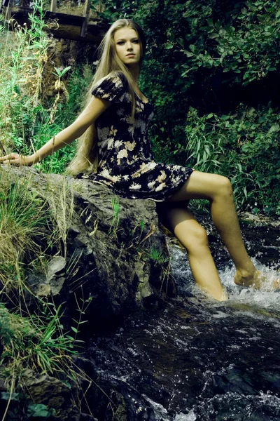 Beautiful girl on stones — Stock Photo, Image