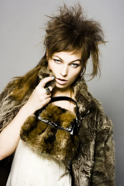 Sexy woman in fur coat with bag — Stock Photo, Image