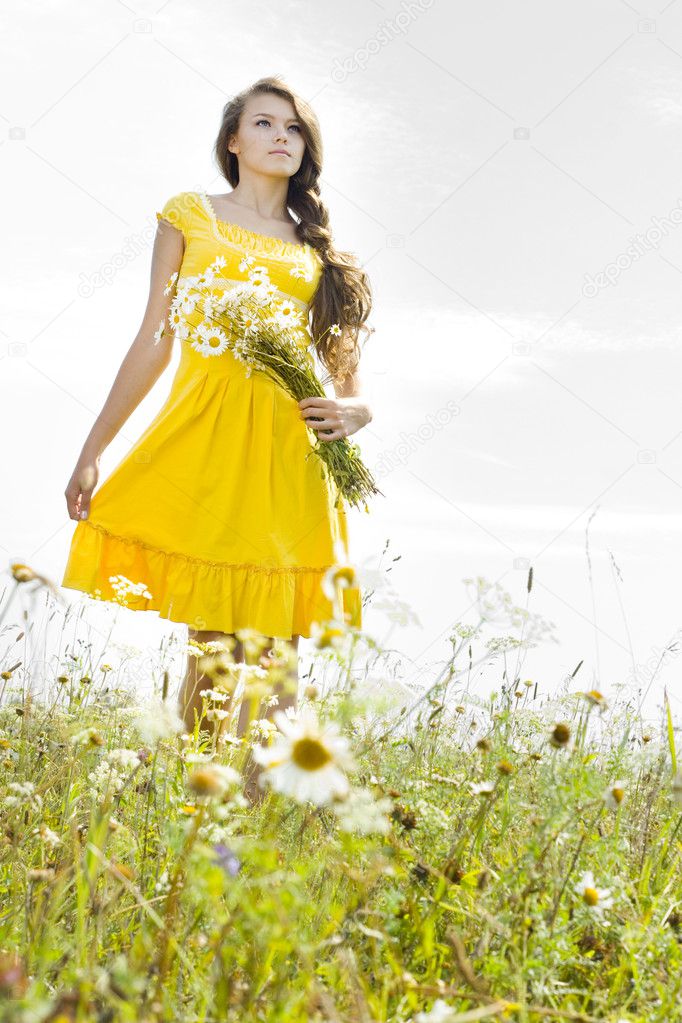 Beautiful girl in green field