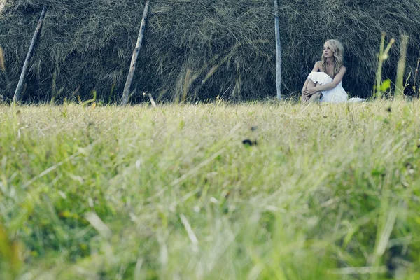 Beautiful sexy young near a haystack — Stock Photo, Image