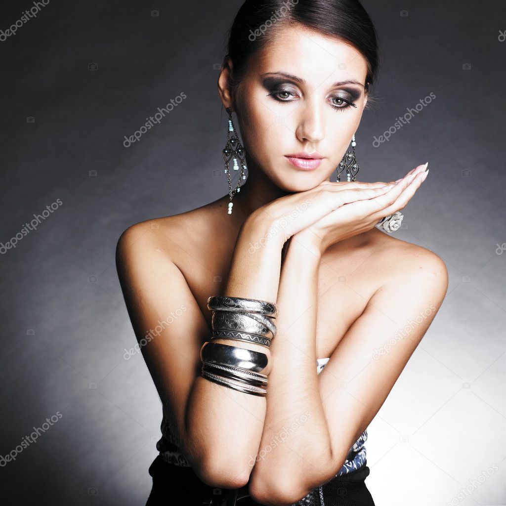 Beautiful woman with evening make-up. Jewelry and Beauty