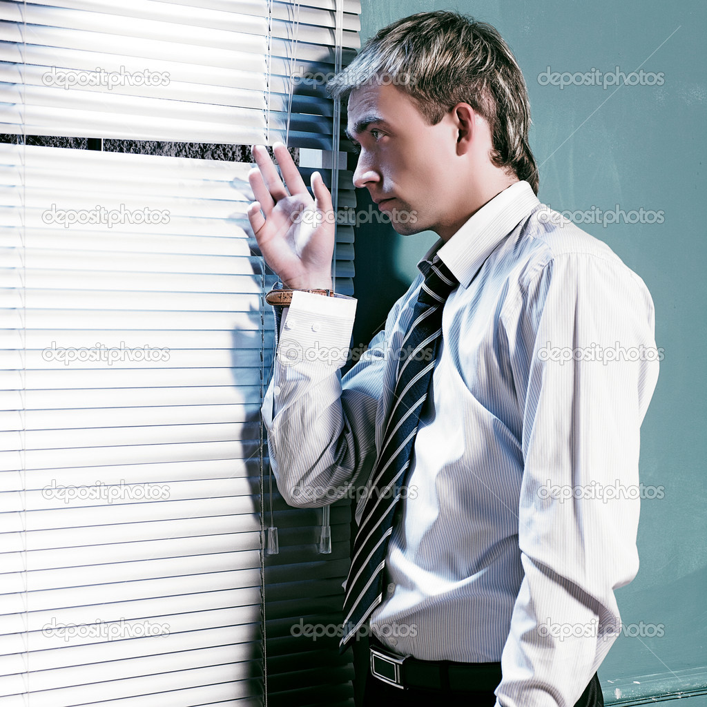 Man in suit look in window