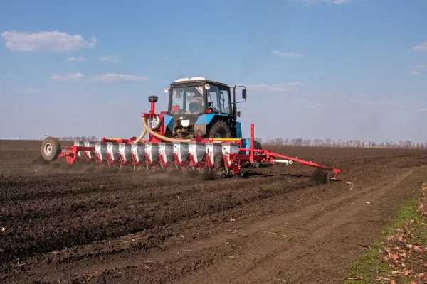 Tractor with sower on the field — Stock Photo, Image