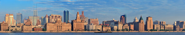 Shanghai historic and urban buildings over Huangpu River in the morning with blue sky.