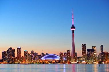 Toronto sunset over lake panorama with urban skyline. clipart