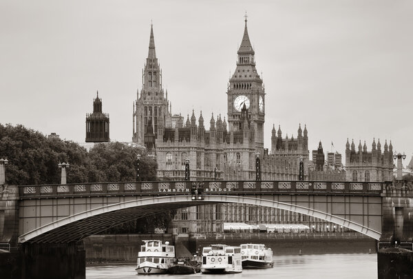 Westminster Palace and bridge over Thames River in London in black and white