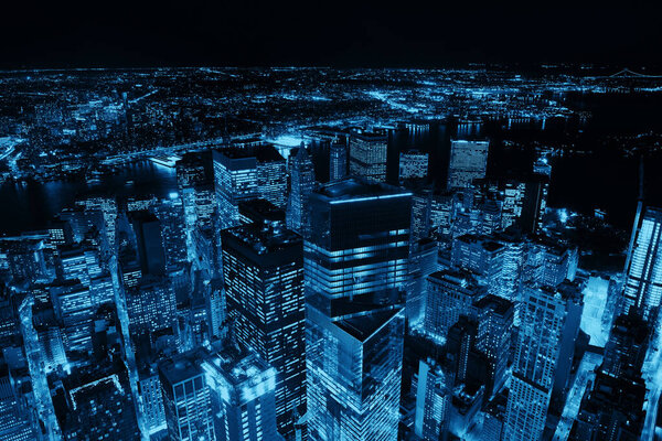 Rooftop night view of New York City downtown with urban skyscrapers