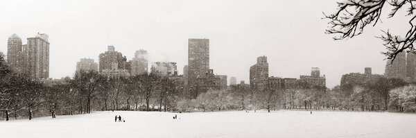 Central Park winter in snow with skyscrapers in midtown Manhattan New York City
