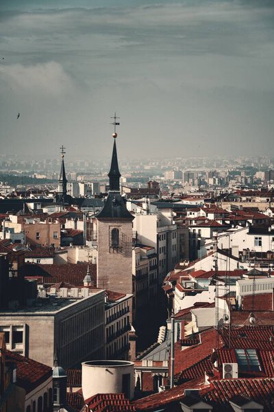 Madrid skyline rooftop view with buildings and church bell tower in Spain