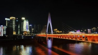 Chongqing şehir mimarisi ve Qiansimen köprüsü gece Çin 'de nehrin karşı kıyısında.