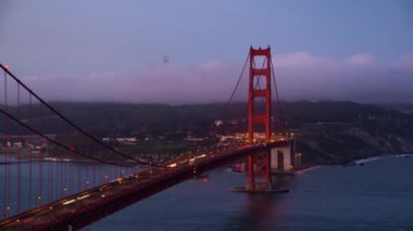 Golden Gate Köprüsü 'nün zaman ayarlı görüntüsü, San Francisco' nun ünlü simgesi olarak karanlık ve gün doğumundan gündoğumuna kadar.