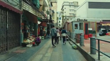 GUANGZHOU, CHINA - OCT 2, 2021: Urban city street view with stores and pedestrians