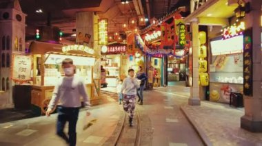 GUANGZHOU, CHINA - OCT 2, 2021: Urban city street view with stores and pedestrians
