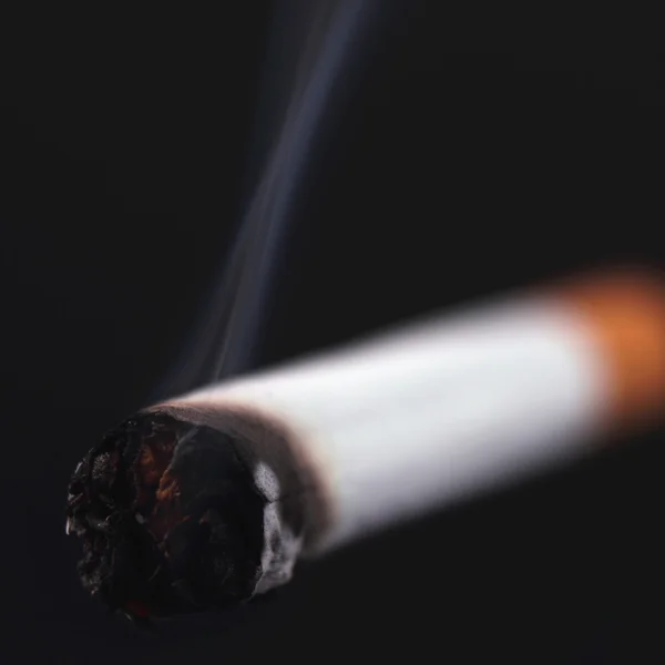 Cigarette on a black background — Stock Photo, Image