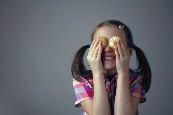 Divertido Retrato Una Joven Hermosa Niña Coloca Mandarina Sus Dos — Foto de Stock