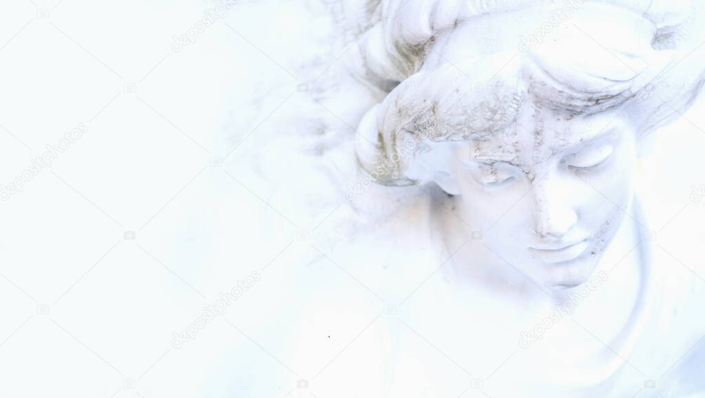 Fragment of ancient statue of beautiful white guardian angel.  Copy space.