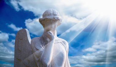 Guardian angel in sunlight against blue sky