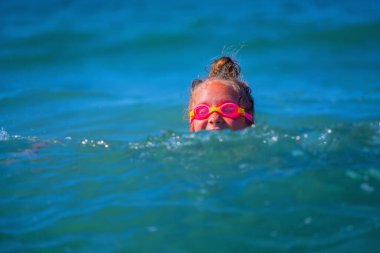 Dalgaları kıran mutlu kız çocuğu. Metin veya tasarım için boşluk kopyala.