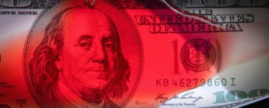 US Dollar bill in blood as symbol of bloody business of russian war against Ukraine and democratic system of states of the whole world. Horizontal image.