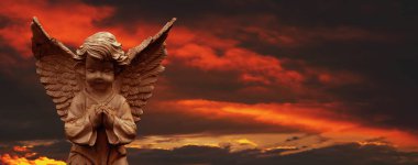 Ancient statue of little guardian angel. Copy space.