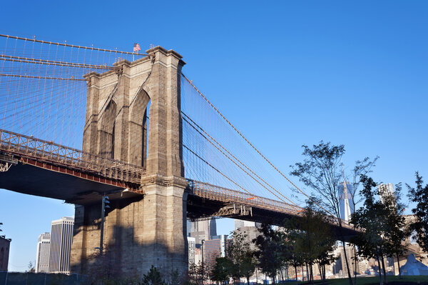Brooklyn Bridge over East River viewed from DUMBO Brooklyn waterfront in morning.