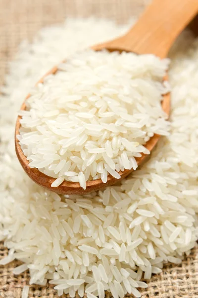 Rice with wooden spoon — Stok fotoğraf