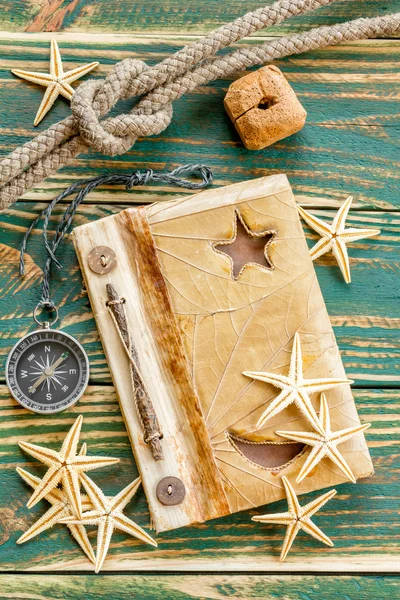 Old notepad with seashells on the deck — Stock Photo, Image