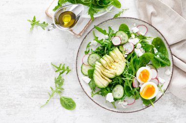 Avokado ve haşlanmış yumurta taze sebze salatası turp, salatalık, ıspanak, roka ve süzme peynirli. Üst görünüm