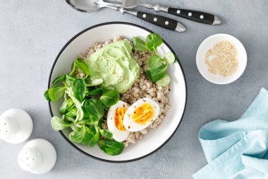 Yumuşak yumurta ve mısır salatalı inci arpa kasesi.