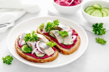 Sandwiches, toasts with salted herring and beetroot pate