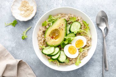Haşlanmış yumurta, salatalık ve avokado ile yulaf lapası.