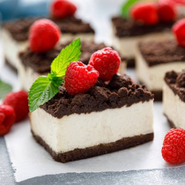 Çikolatalı kek, dilimlenmiş browni peynirli kek ve taze ahududu.