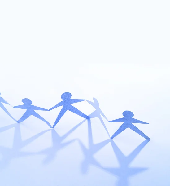 Team of paper doll holding hands. Teamwork concept — Stock Photo, Image