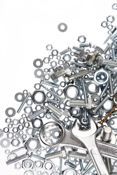 Wrenches, nuts and bolts on plain background — Stock Photo, Image