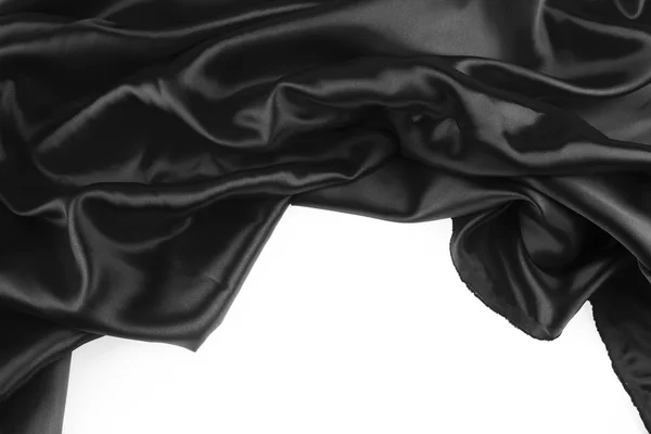 Крупный план складок из черной шелковой ткани — стоковое фото