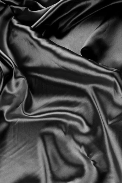 Primer plano de pliegues en tela de seda negra — Foto de Stock