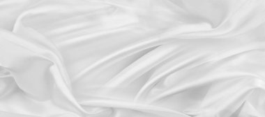 Dalgalı beyaz ipek kumaş dokusunun yakın plan görüntüsü