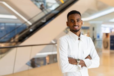 Portrait of young handsome stylish black man enjoying city life