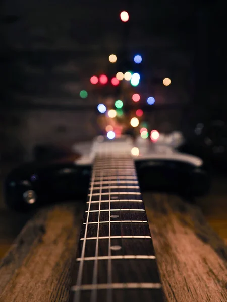 木の板の上にクリスマスライトとテキストのためのスペースと古い中古ヴィンテージギター — ストック写真