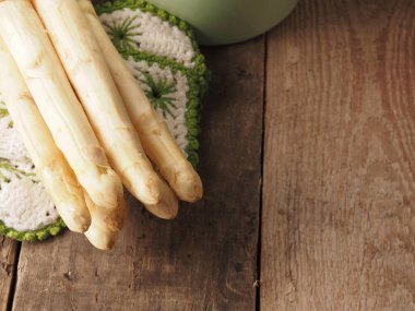 Köy ahşap bir masada taze, taze organik kuşkonmaz, mevsimsel gıda konsepti.