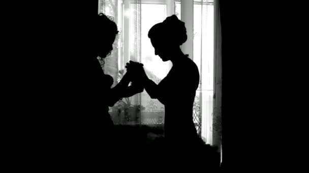 Silhouette of bride. Silhouette of bride stands against the window. — Stock Video