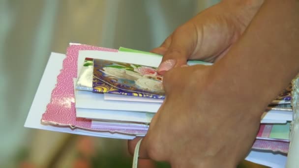 Bride is holding greeting cards — Stock Video