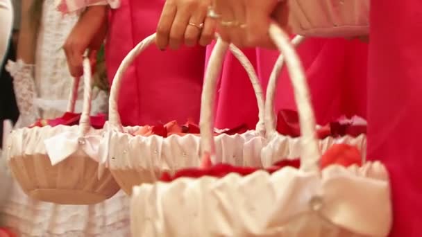 Bridesmaids with baskets filled with rose petals. — Stock Video