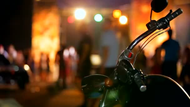 Disco biker. Rudder rarity motorcycle close up. In the background a disco. — Stock Video